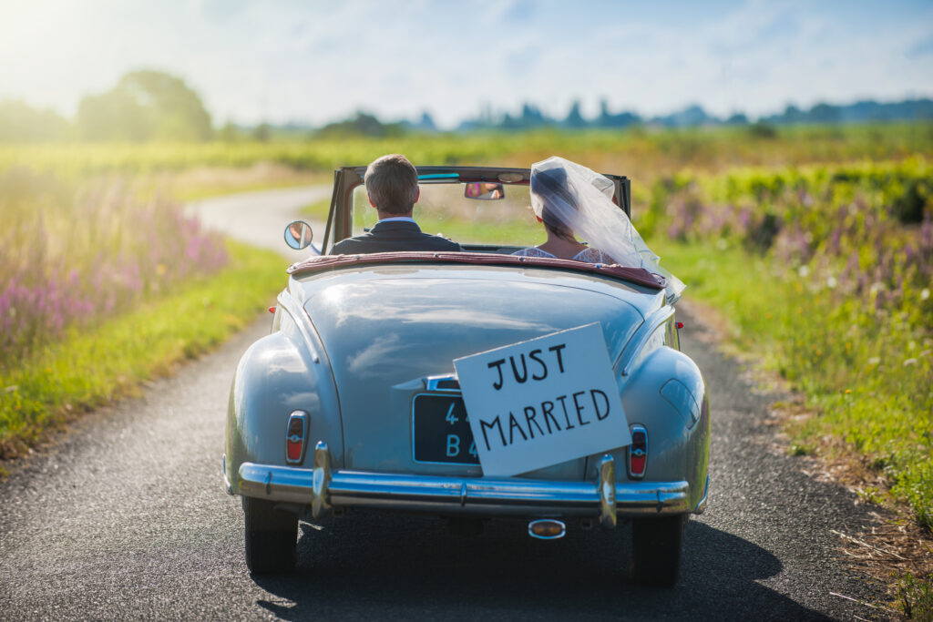 A,Newlywed,Couple,Is,Driving,A,Convertible,Retro,Car,On